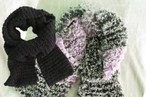 a black and a purple and black striped scarf