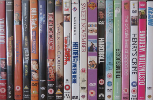 DVDs of Keanu Reeves rom coms and comedies on a shelf