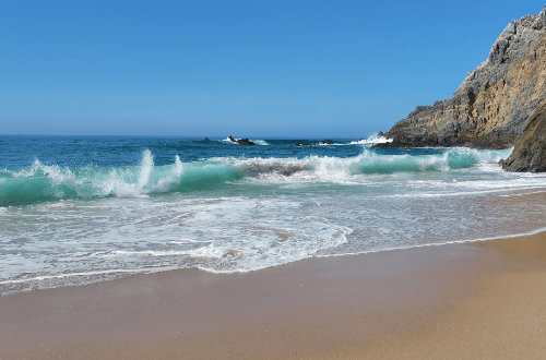 A rocky beach with waves.